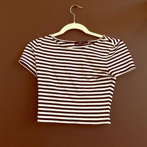 A cropped black and white tight cropped tee