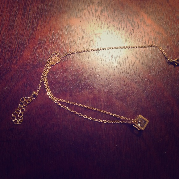 A metric necklace with a  Crystal inside