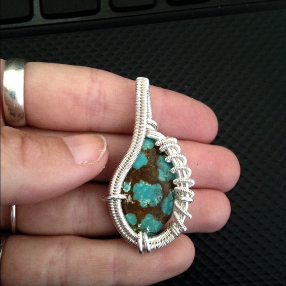 Speckled turquoise stone wrapped in silver