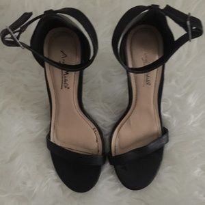 Basic black single strap sandal heels.