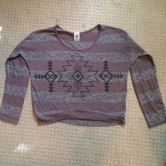A thin small long sleeve shirt with Indian symbols