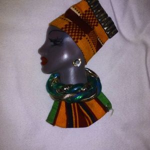 Lapel pin of black woman in African garb