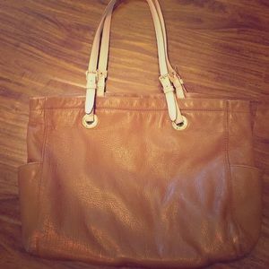 Light brown leather Michael Kors handbag.