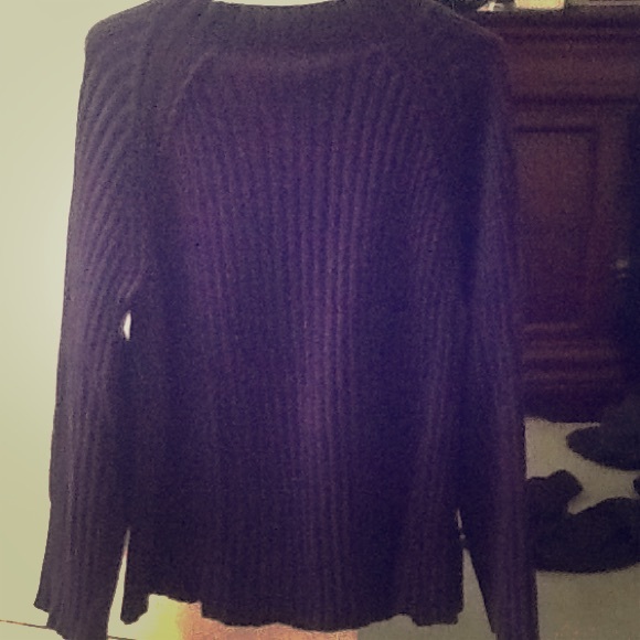 Long ribbed sweater hits at hip.