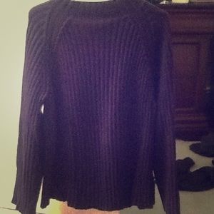 Long ribbed sweater hits at hip.