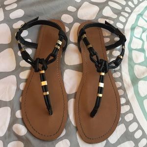 Black and gold sandals and grey shirts