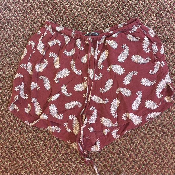 Maroon shorts, dress, and white cropped top