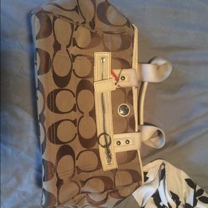 Tan and white coach purse