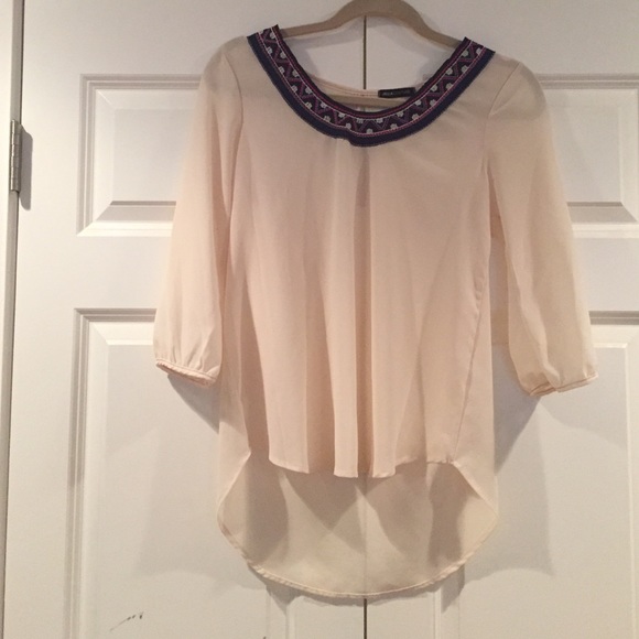 Beige top with tribal print around the neck line