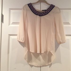 Beige top with tribal print around the neck line