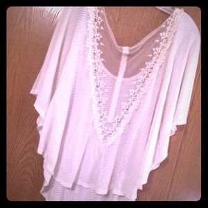 White short sleeved top with a unique back.