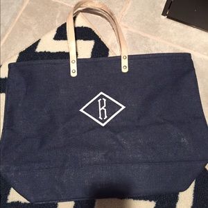 Navy blue beach bag with "K" initial