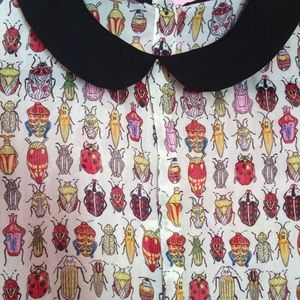 Sheer beetle blouse.