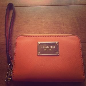 Orange Michael Kors wristlet