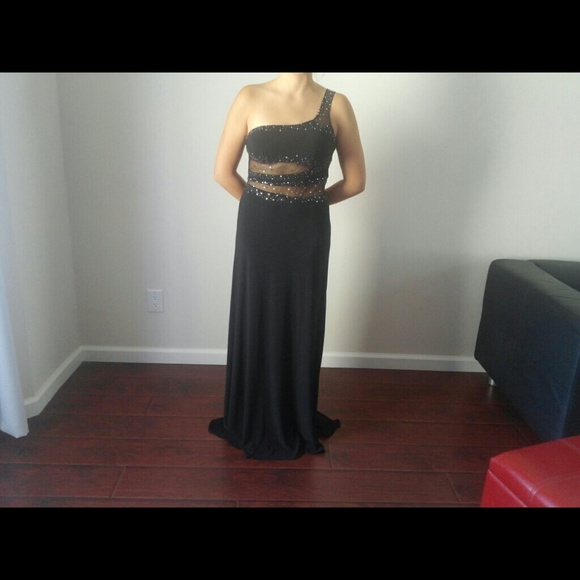 Beautiful black dress with a train .