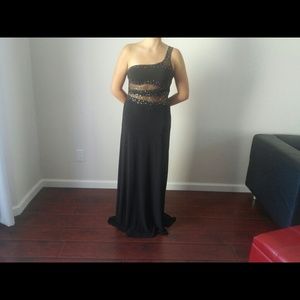 Beautiful black dress with a train .