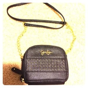 Jessica Simpson black purse with gold chain.