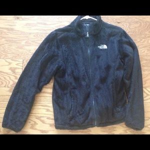 Black fuzzy north face jacket.