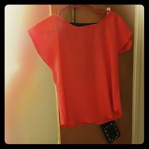 Orange shirt cut out back W navy blue bows