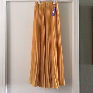 Mustard yellow pleated maxi skirt.