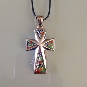 Cross pendent with leather chain.