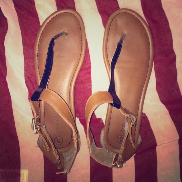 Black and brown sandals that zip in the back