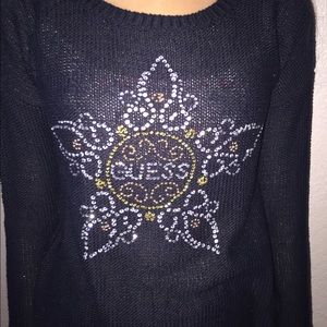 a black sweater with tine stones