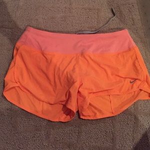 Orange day glow Nike running shorts
