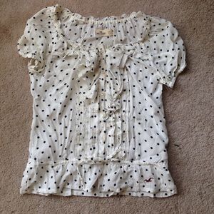 White and blue poke a dot blouse.