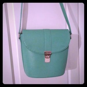 A teal hand bag bought from Charming Charlies