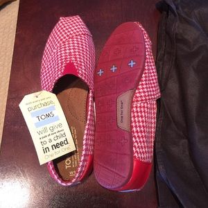 Brand new pair of red and white Toms shoes!