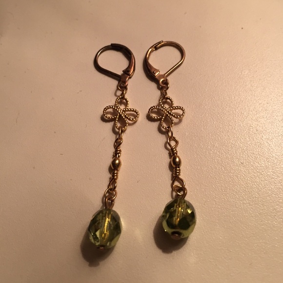 Gold dangle earrings with green bead