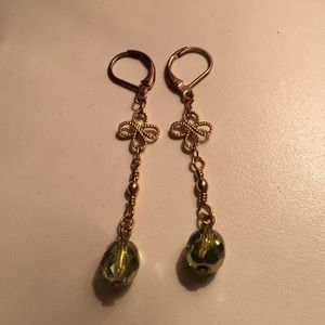 Gold dangle earrings with green bead
