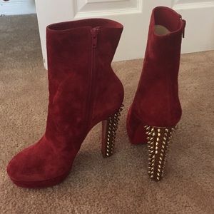 Red suede boots with gold studded heel.
