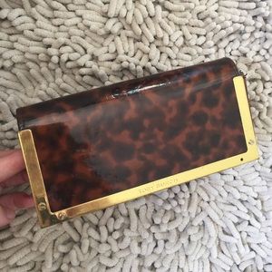 Tory Burch sunglasses case.