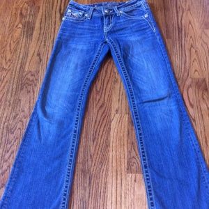 Foot-length Miss Me jeans.