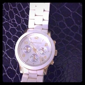 White ladies  Michael kors watch needs a  battery