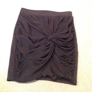 A black pencil skirt with a sheer overlap in front