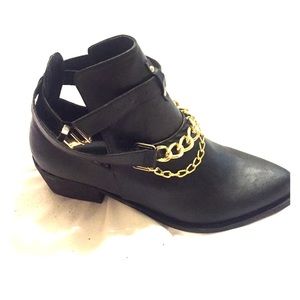 Black, ankle boots with golden chain.