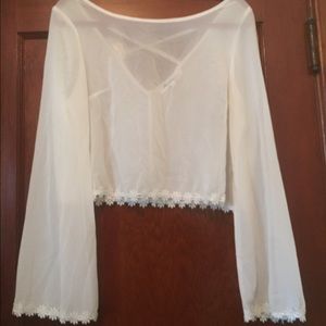 white bell sleeved shirt with floral embroidery