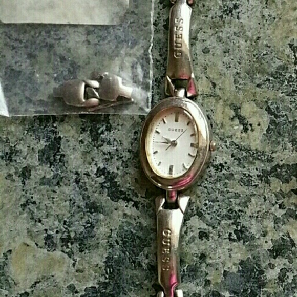 Silver watch with a white face.