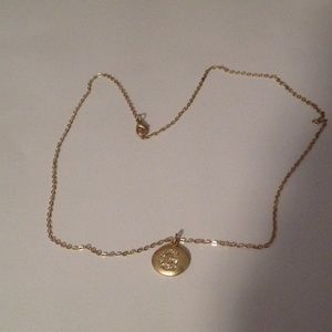 Necklace with a sparkly "G" on it. NOT REAL GOLD.