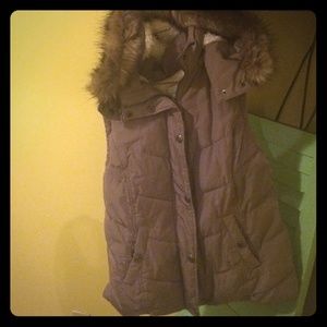 Light brown fur vest with hood.