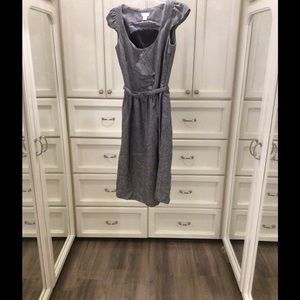 Sfera waist belted dress with ruffle accents.