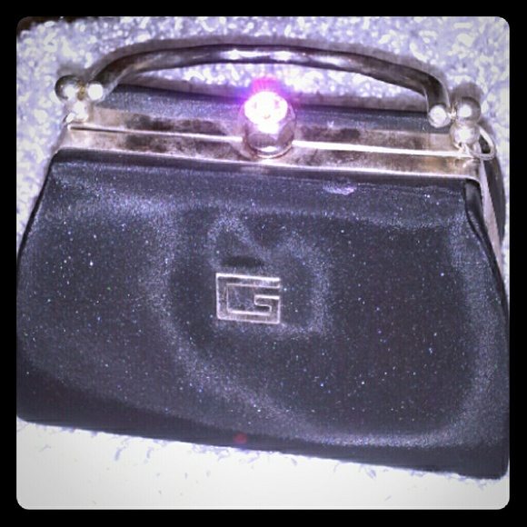 Guess Evening Clutch in Black and Silver trims.