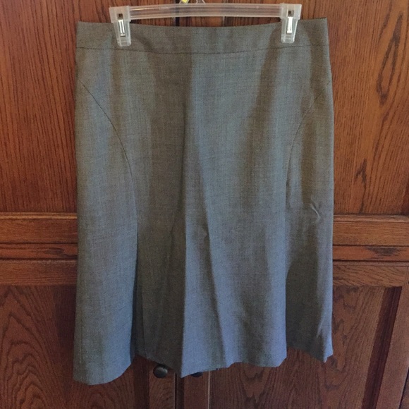 Gently worn dress skirt. Hem sits below the knee.