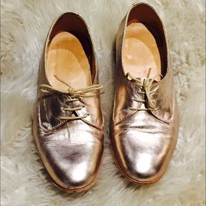 Rose gold leather oxfords.