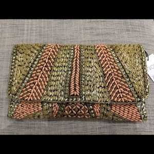 Neutral and metallic beaded Clutch