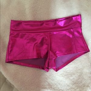 Hot pink metallic spandex shorts.