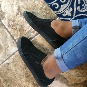 Black Vans slip ons.